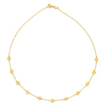 Gold necklace with small round pendants on a white background